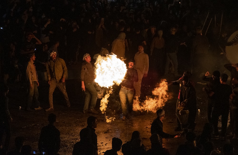 a group of people around a fire