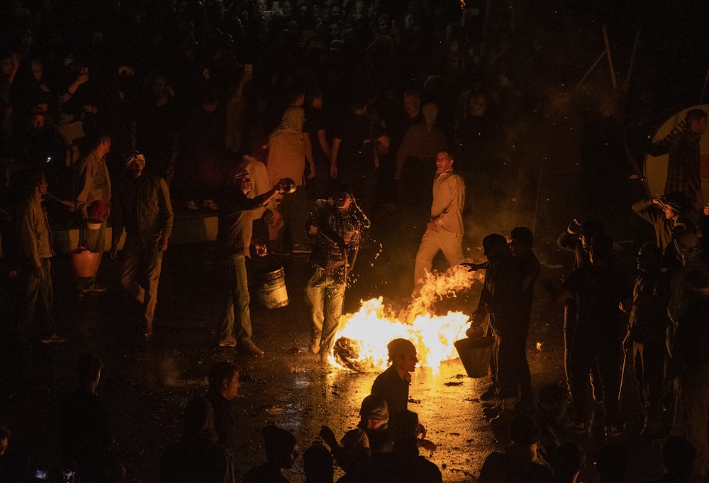 a group of people around a fire