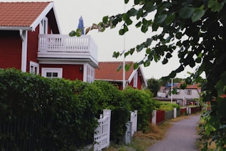 a fenced in yard with a house and trees