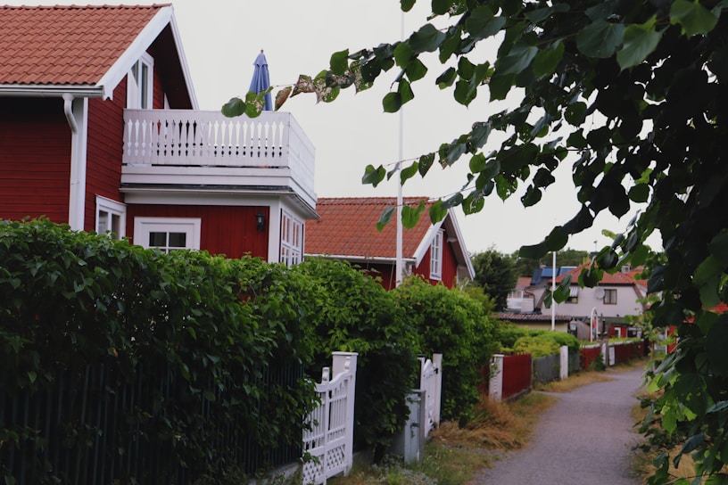 a fenced in yard with a house and trees