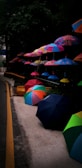 A collection of colorful patio umbrella stands on display.