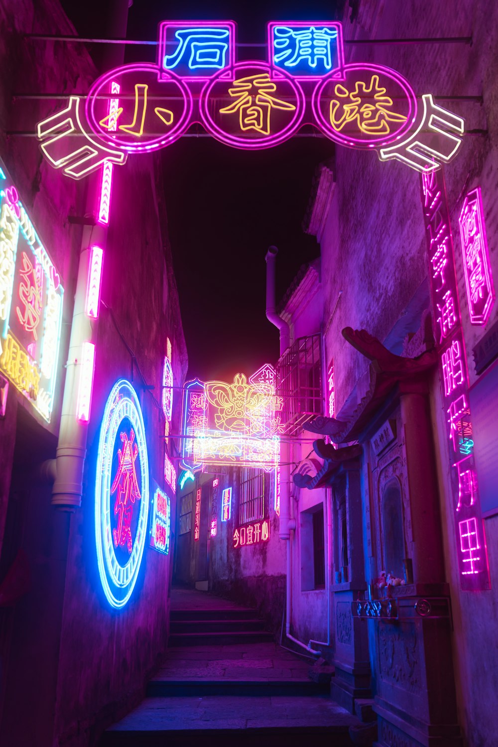 a lit up alleyway with neon signs