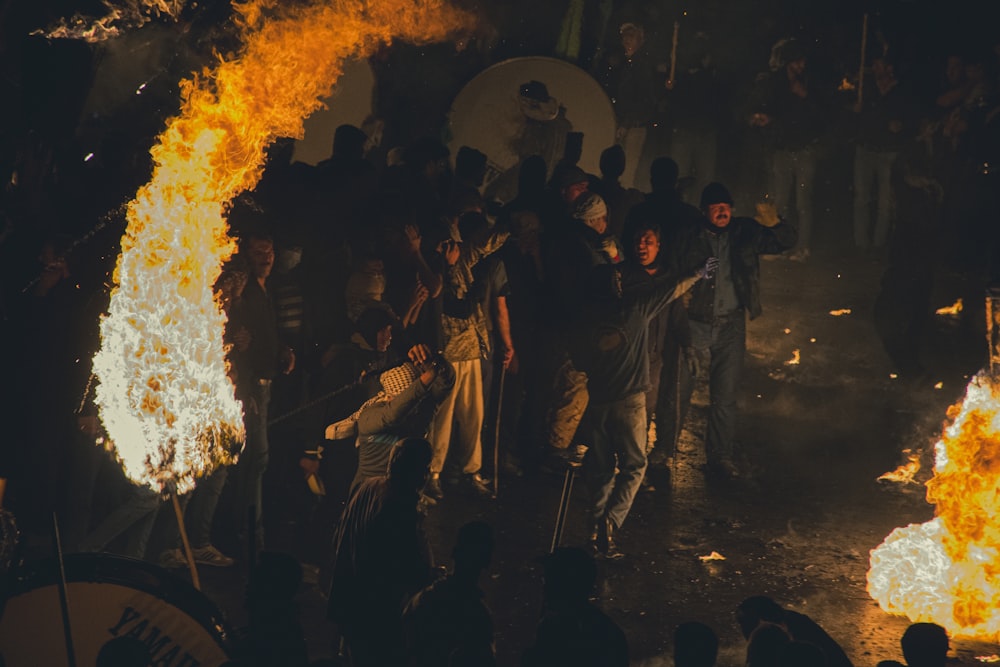 a group of people standing around a fire