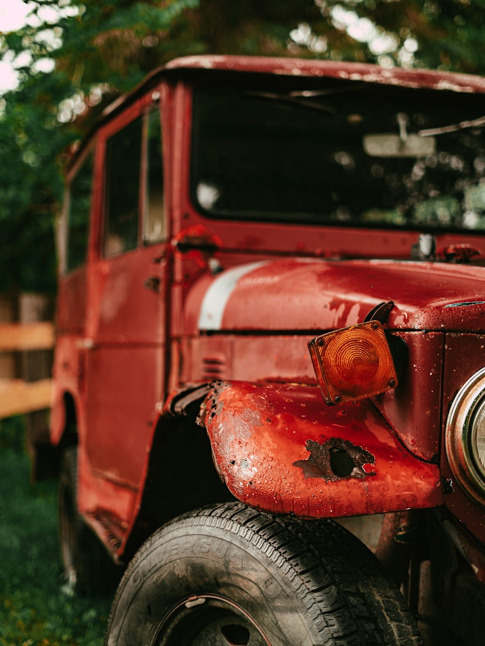 a red car with a dent in the front