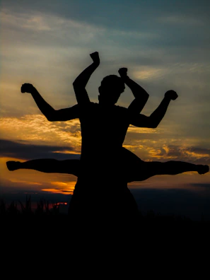 Sunset cityscape with a person holding a Long Jump can, ready for new challenges.