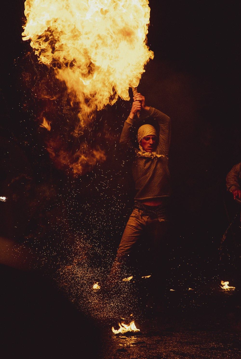 a person standing in front of a large fire