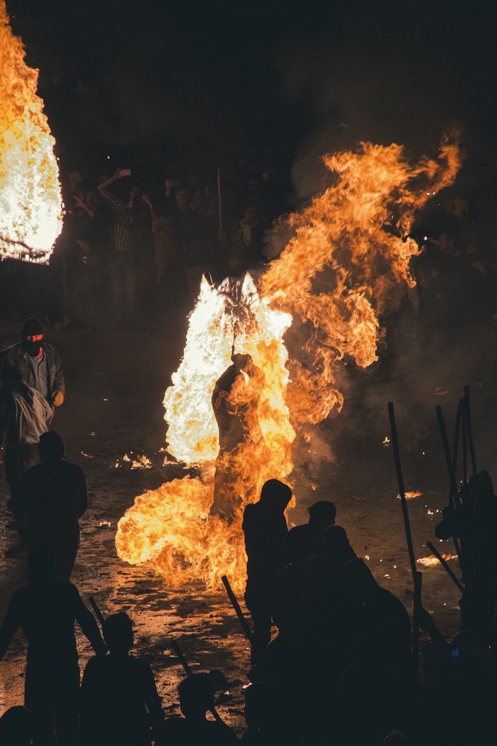 a group of people around a fire with Bonfires of Saint John in the background