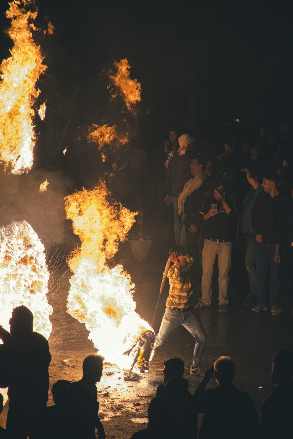 a group of people around a fire with Bonfires of Saint John in the background