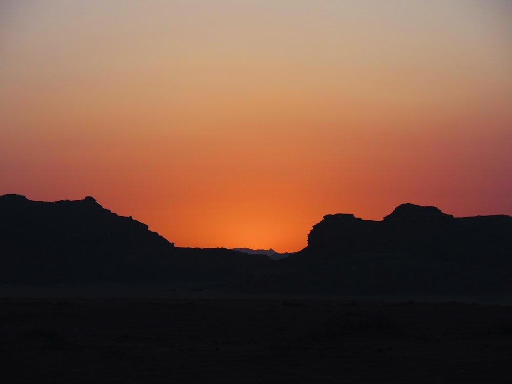 a sunset over a mountain range