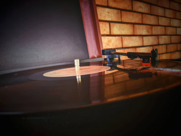 Close-up of a classic 1970s record player with vinyl records stacked nearby.
