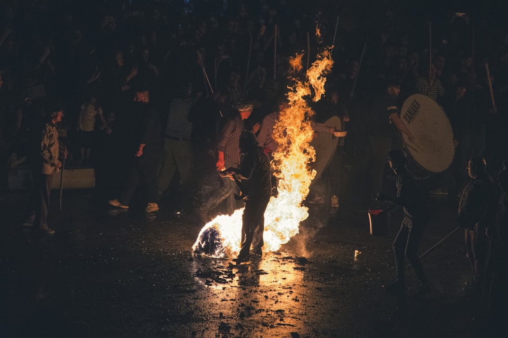 a person holding a large white object with flames coming out of it