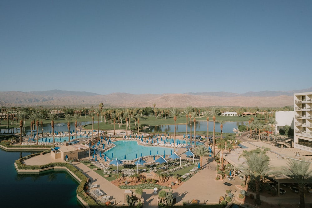 a pool surrounded by buildings and trees