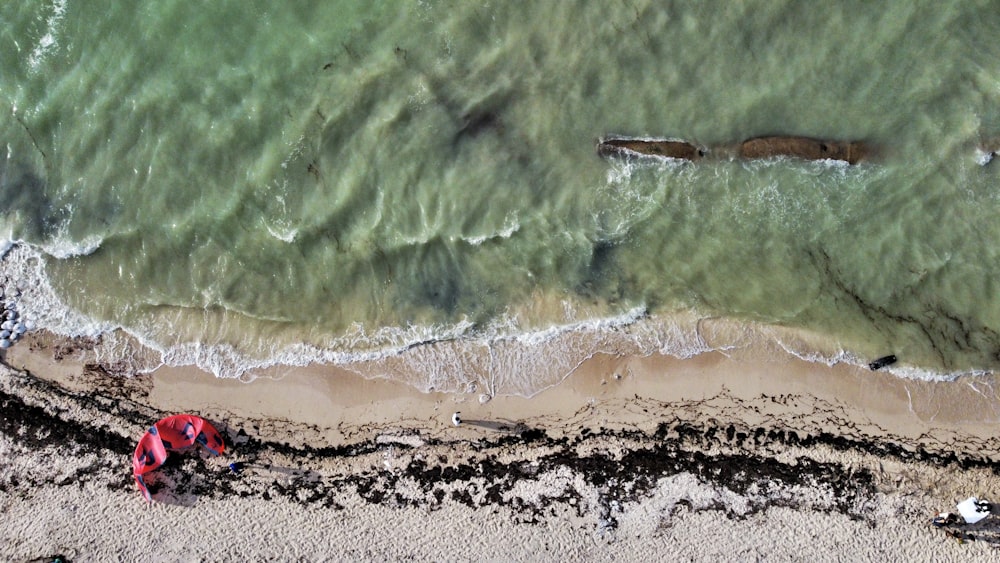 a red toy on a beach