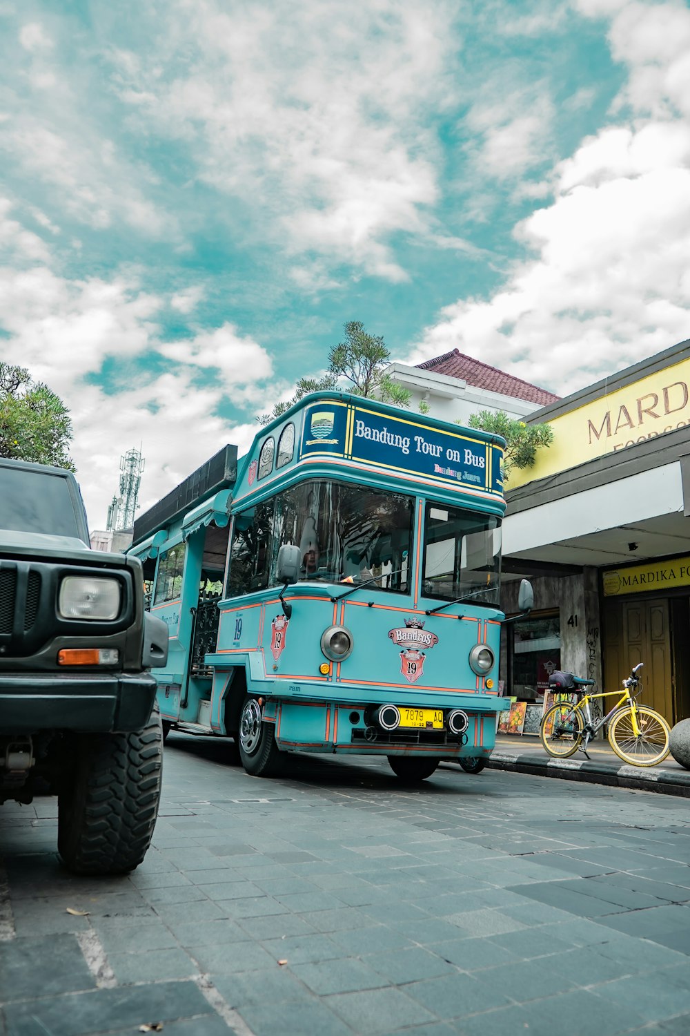 a blue bus parked in front of a store