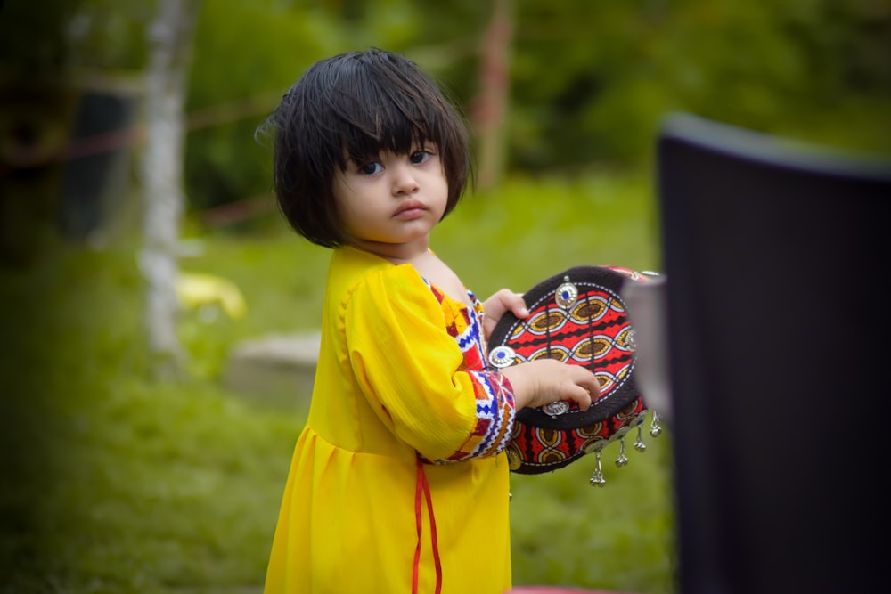 a young girl holding a basket