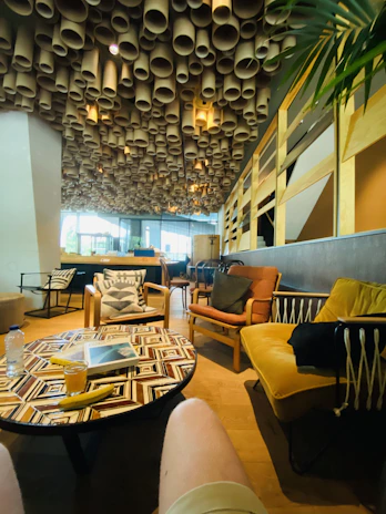 Friendly staff serving tea and juices in a bright, welcoming lounge area.