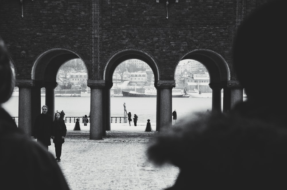 a group of people walking under a bridge