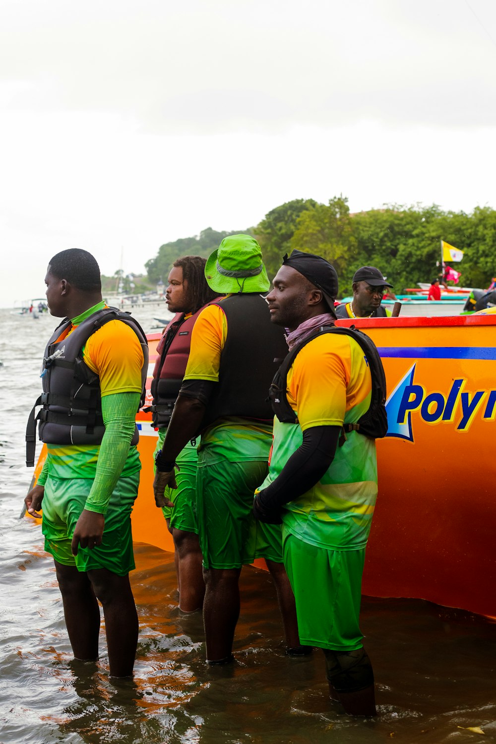 a group of people in rain gear standing in water