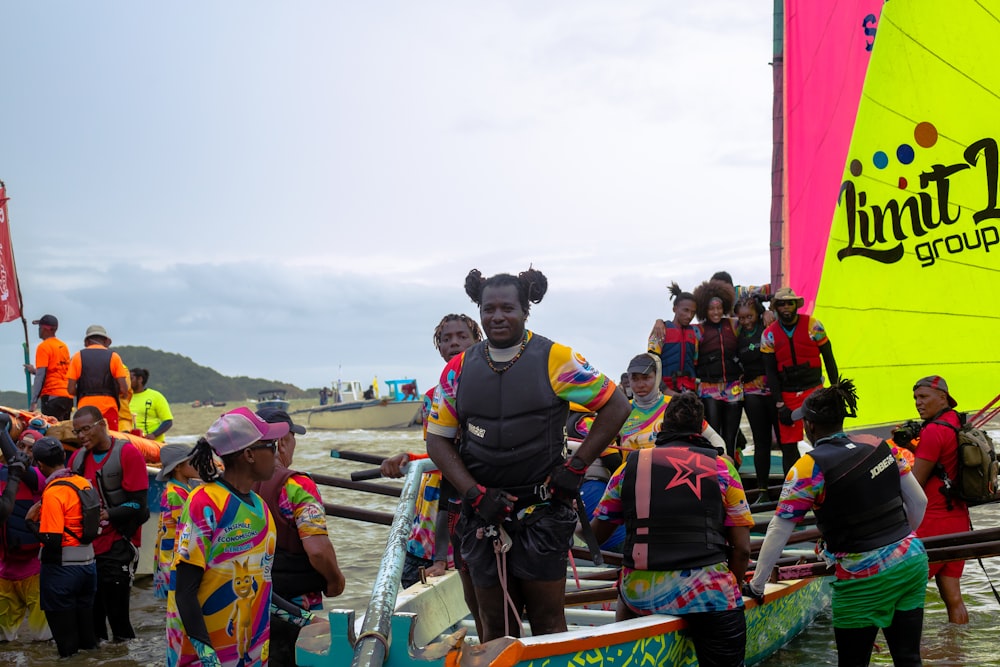 a person standing on a boat with a crowd of people around him