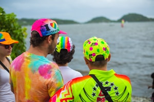 Group of diverse people wearing colorful personalized caps outdoors