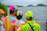 Close-up of a group wearing colorful custom hats with a city skyline in the background.