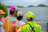 Close-up of a group wearing colorful custom hats with a city skyline in the background.