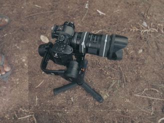L-shaped bracket securely holding a camera cable on a tripod during an outdoor shoot