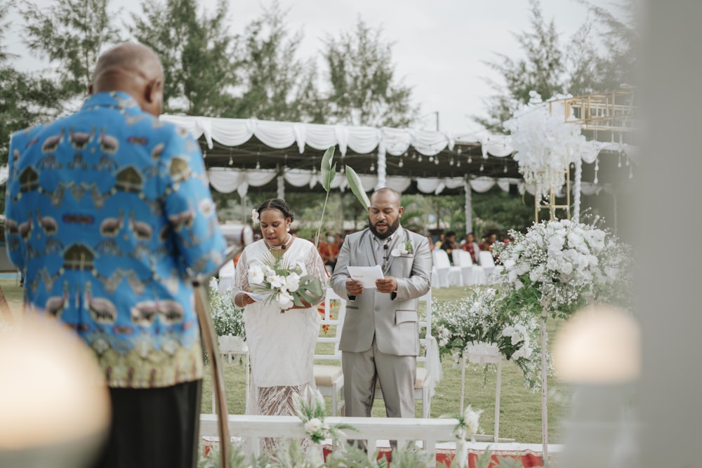 a man and woman holding flowers