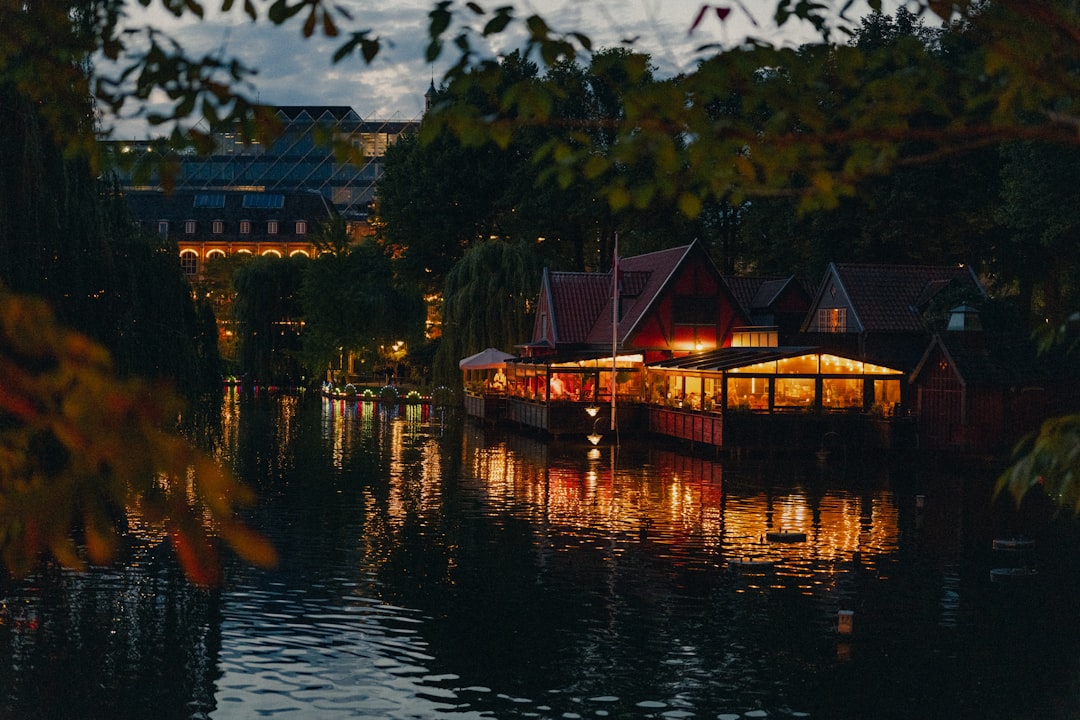 a body of water with buildings along it, The floating restaurant at the oriental lake in Copenhagen