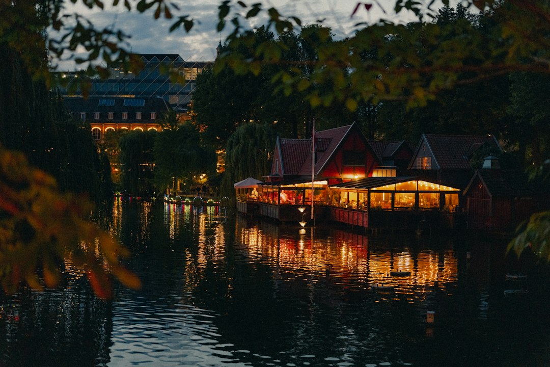 a body of water with buildings along it, The floating restaurant at the oriental lake in Copenhagen