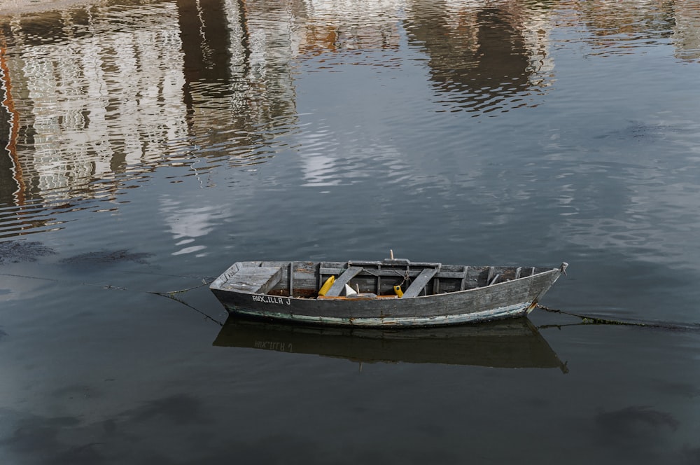 a boat sits in the middle of a lake