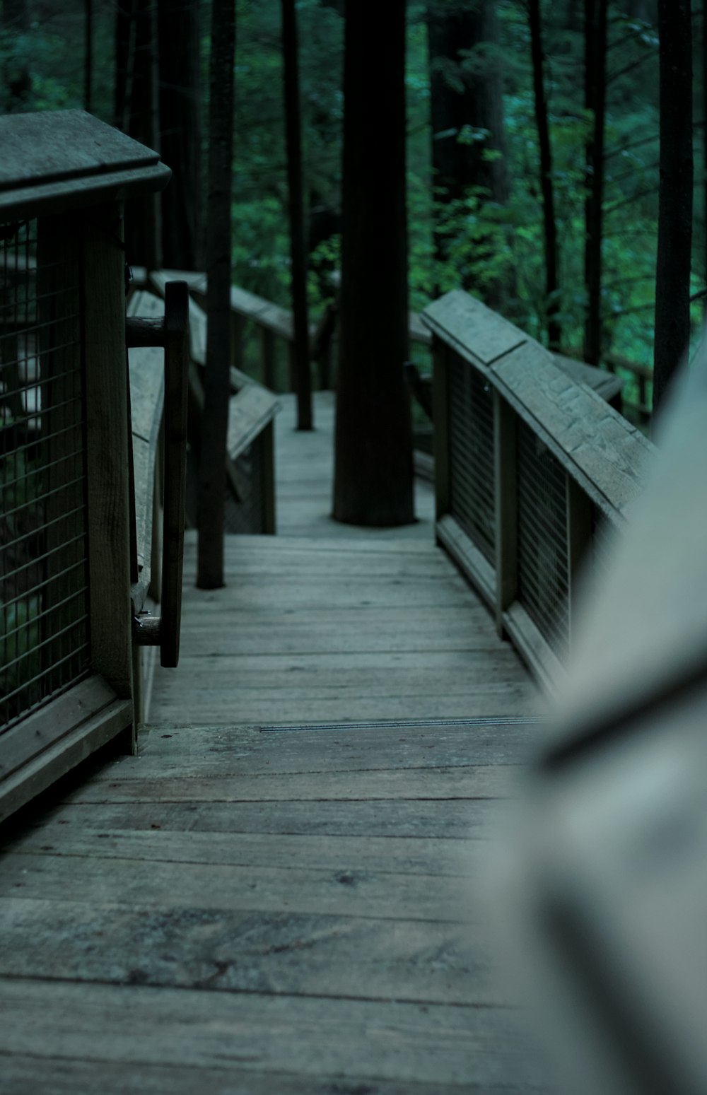 a wooden bridge with a railing