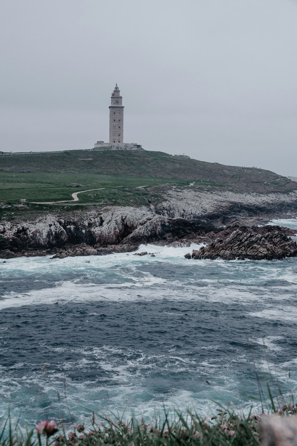 a lighthouse on a rocky hill