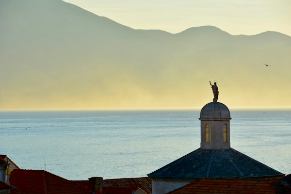 A statue on a dome against the sea — Korčula, Croatia