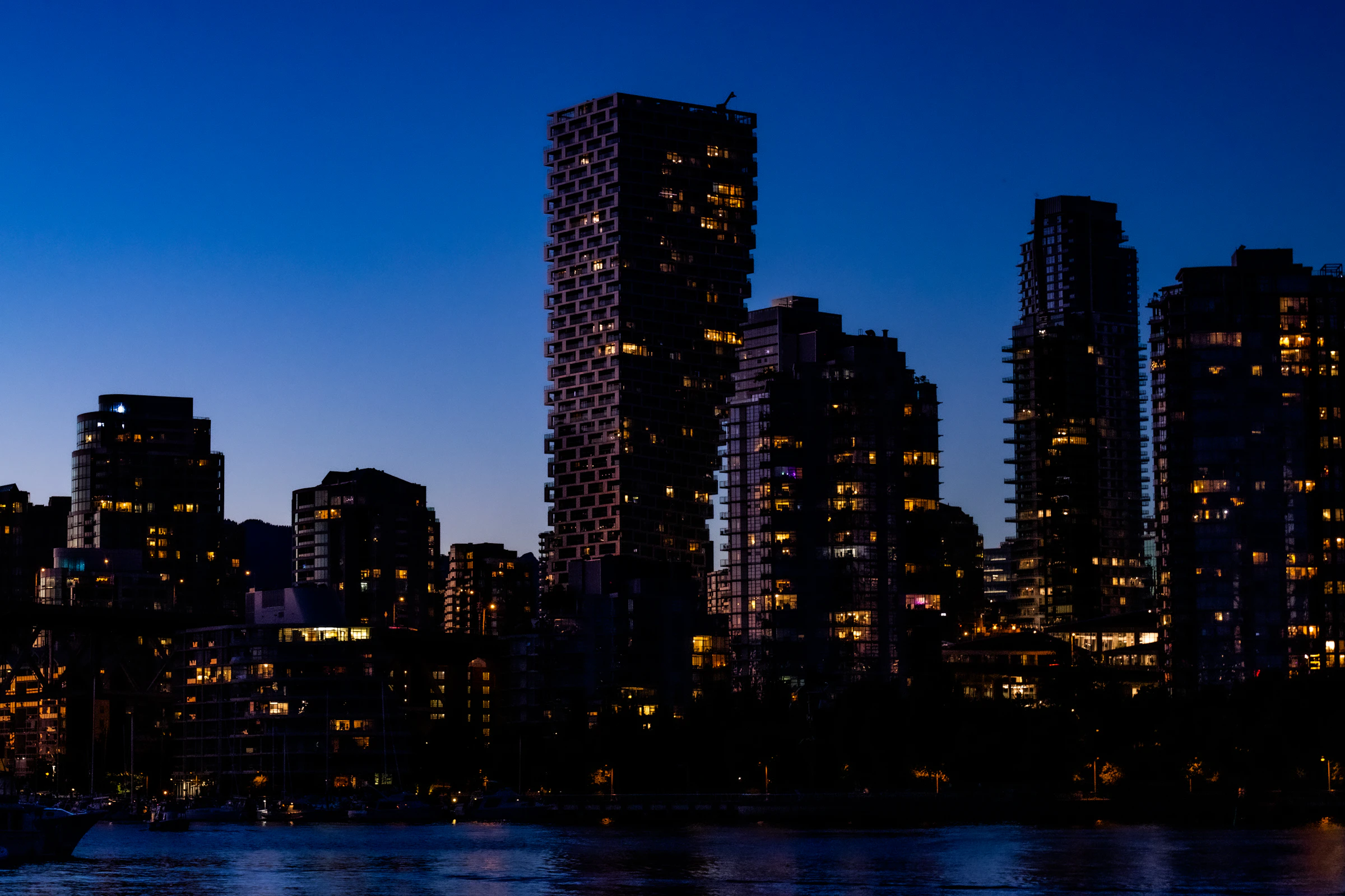 Vancouver towers against a deep blue sky before dawn