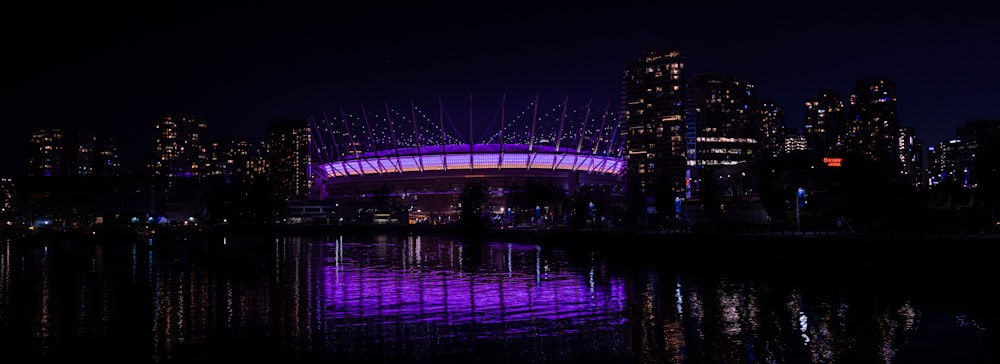 a bridge over water with a city in the background