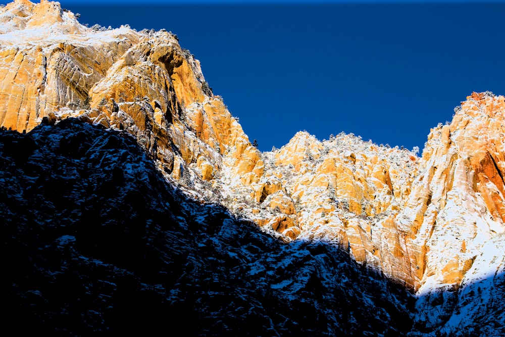 a snowy mountain with a blue sky