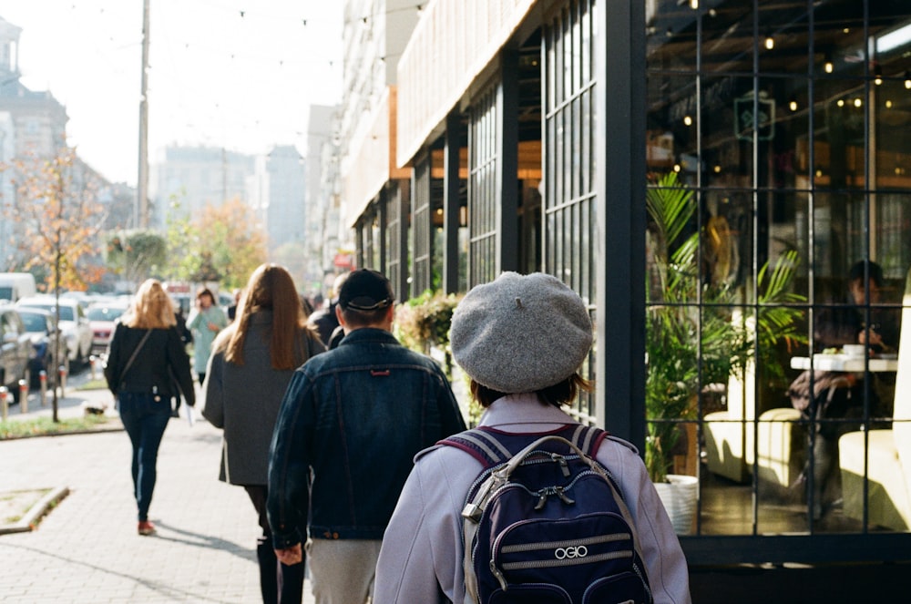 a group of people walking on a sidewalk