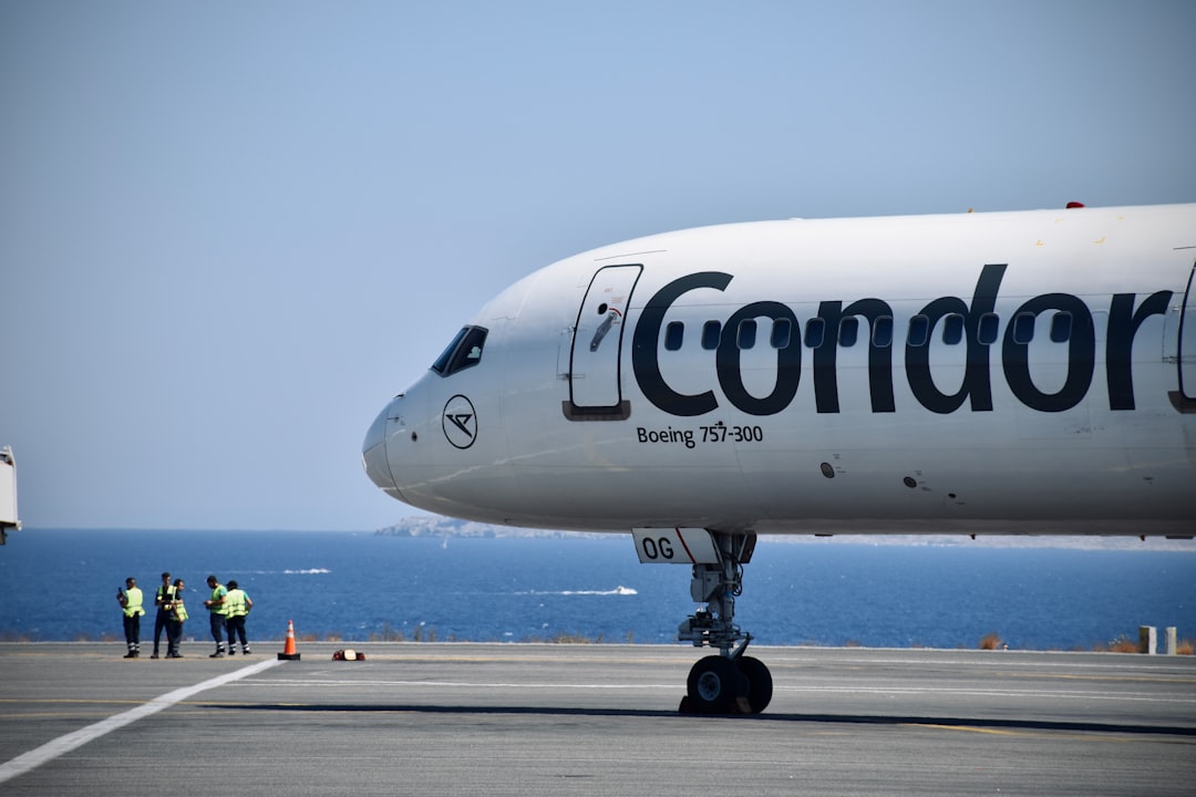 a large white airplane on a runway, Rare Boeing 757-300 bird ready for departure.