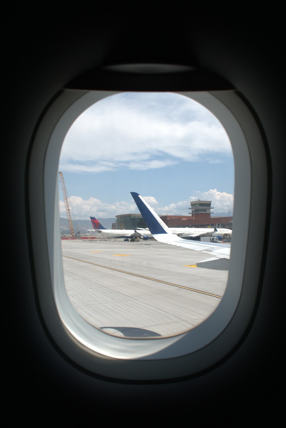 a view of an airplane wing and the wing of another plane