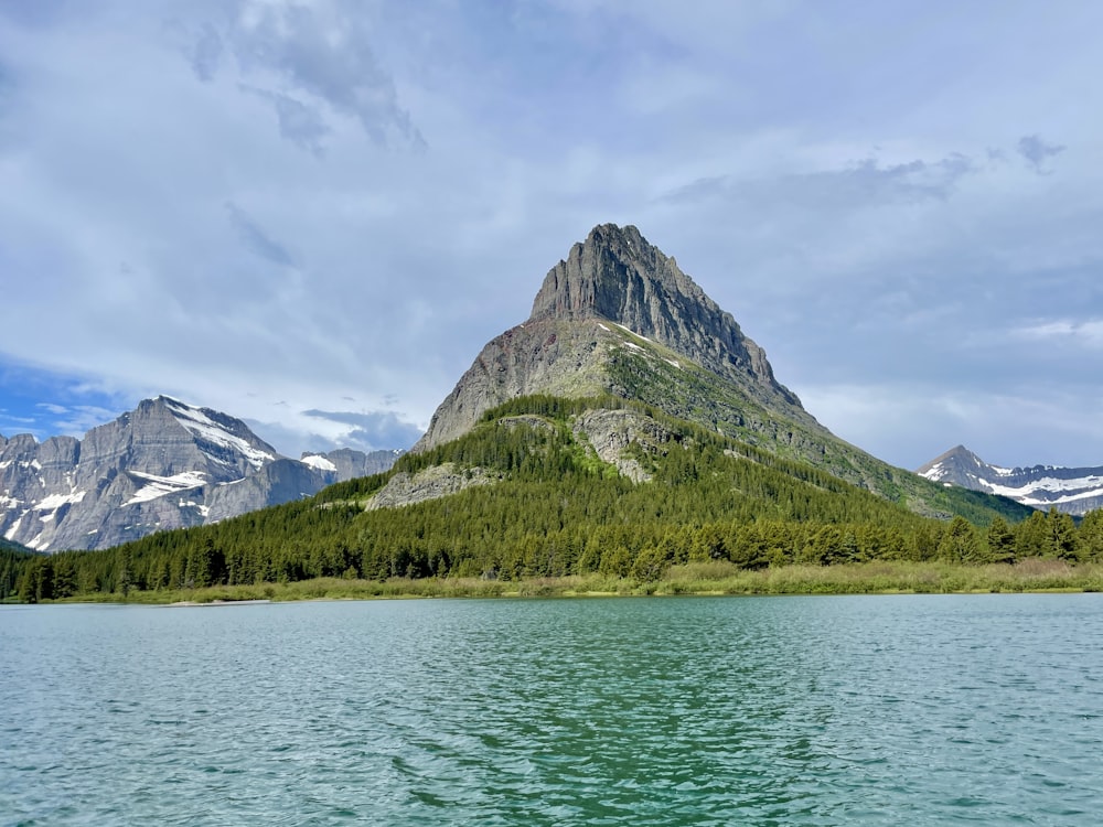 a body of water with a mountain in the background