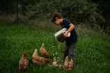 a boy holding a bucket of water