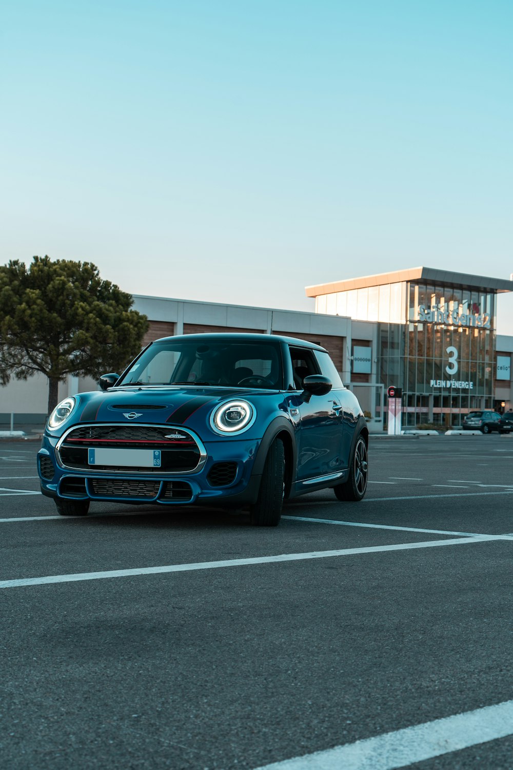 a blue car parked in a parking lot