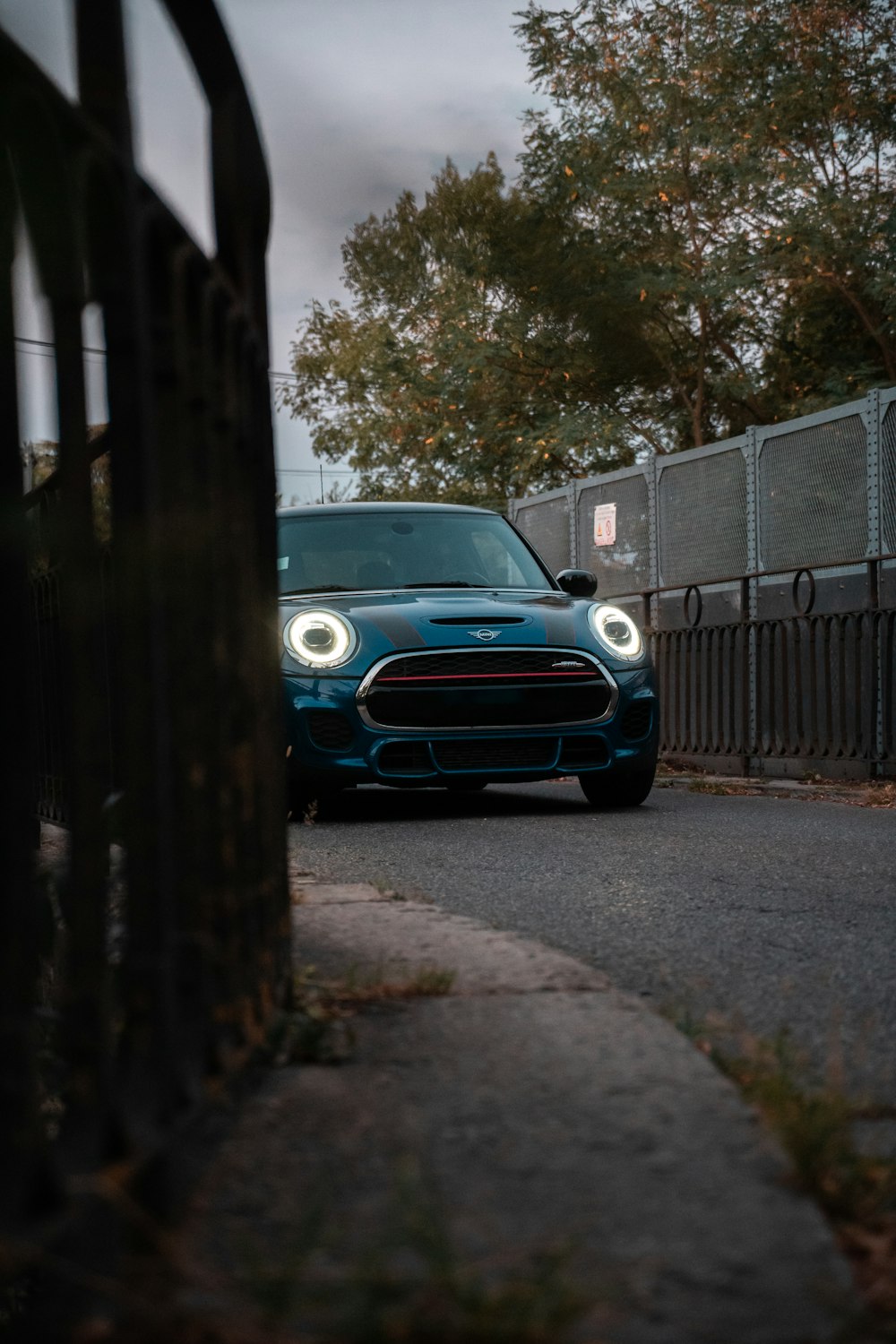 a blue car parked on a road