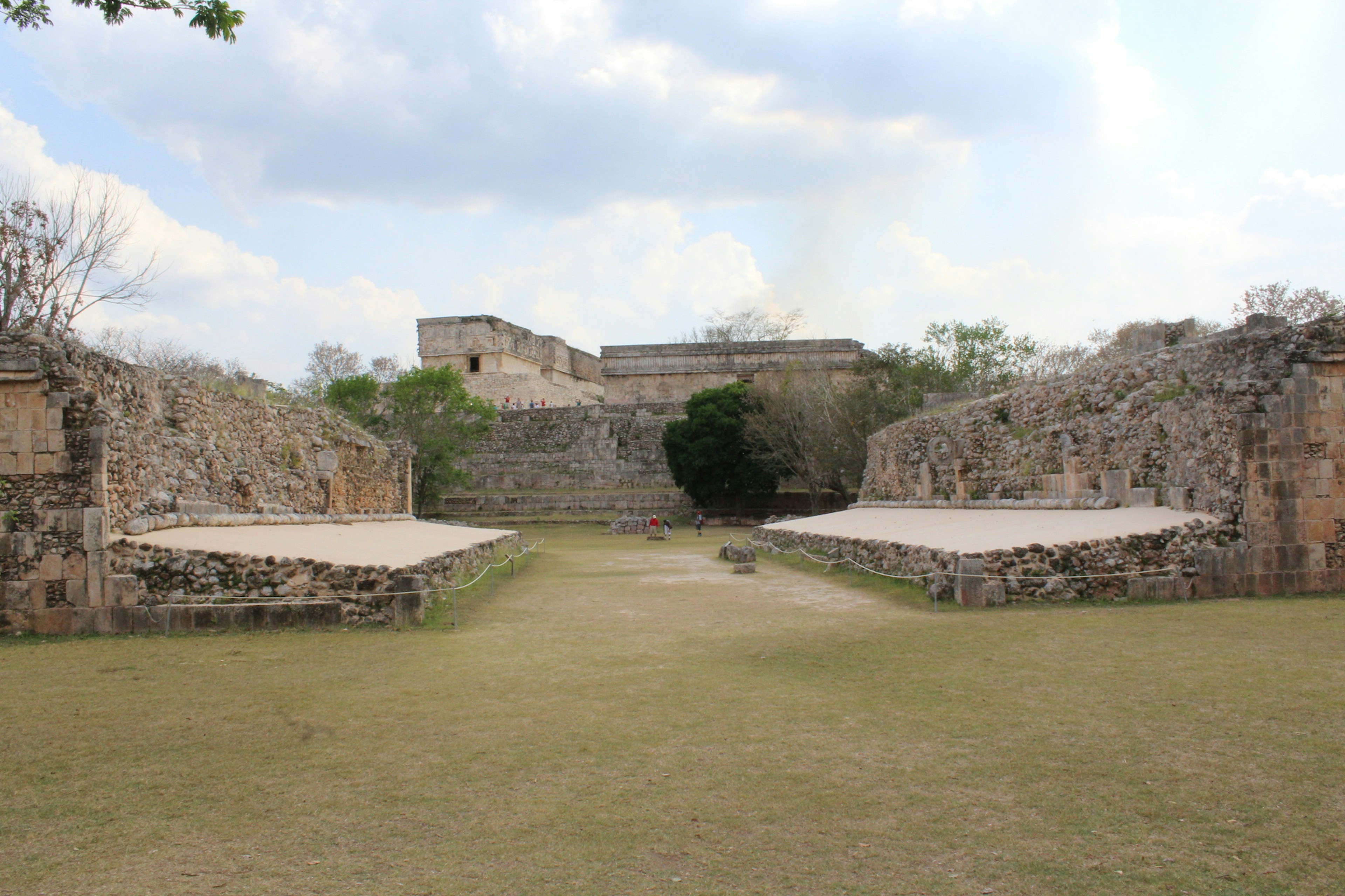 a stone building with a grass field