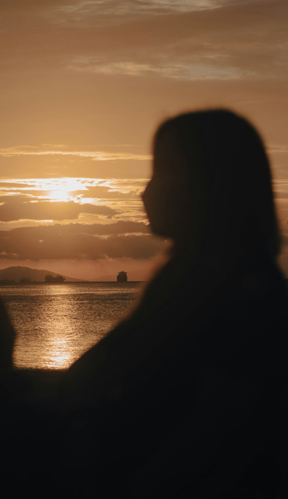 a person's back with a body of water in the background