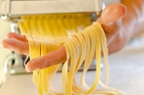 a person holding a yellow container with yellow cables