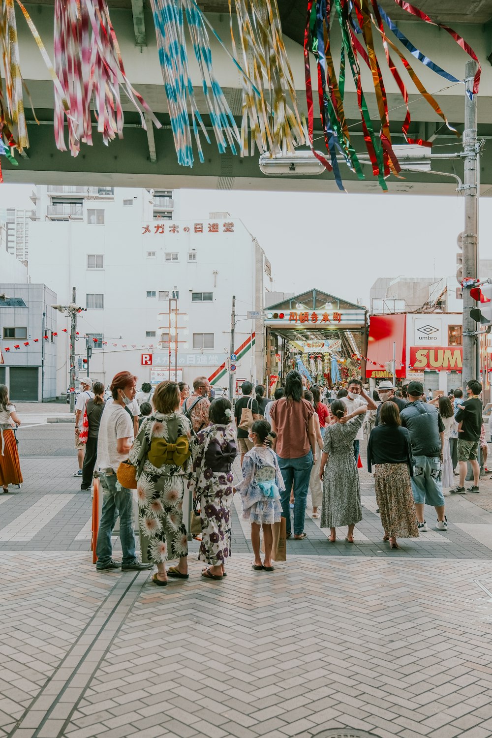 a group of people standing in a street