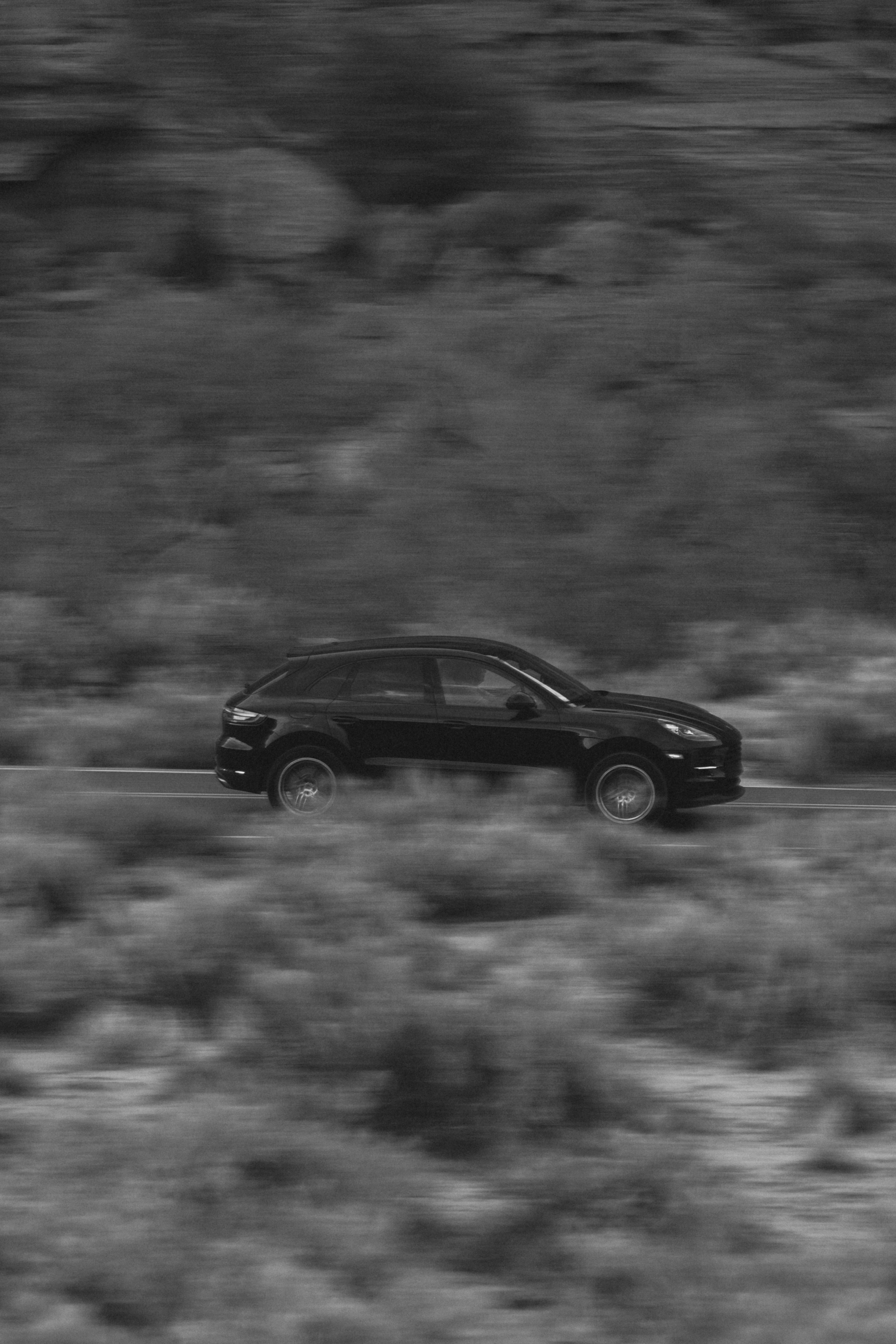 A black car driving on a road photo Free Image on Unsplash