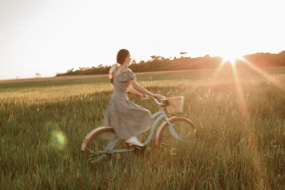 a man riding a bicycle in a field